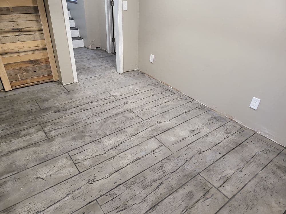 Interior room with gray wood-look tile flooring and light-colored walls, showcasing entryway.